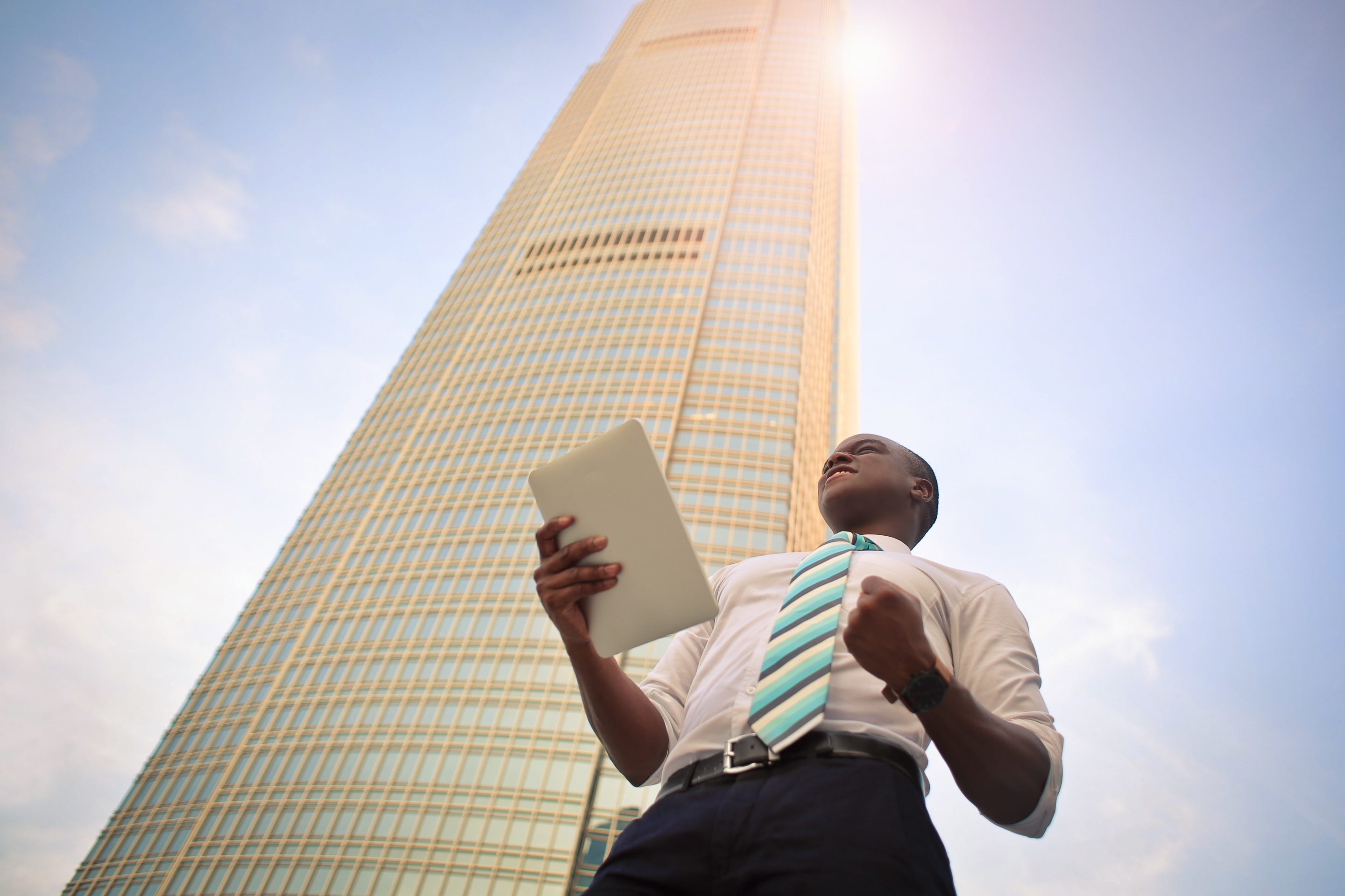 Successful man standing in front of a tall building