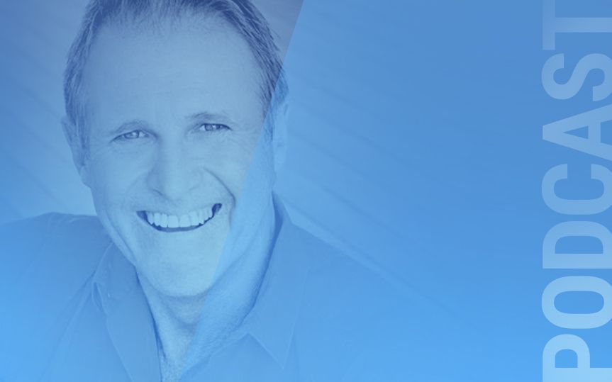Man (Steve Brossman) smiling in a blue faded background